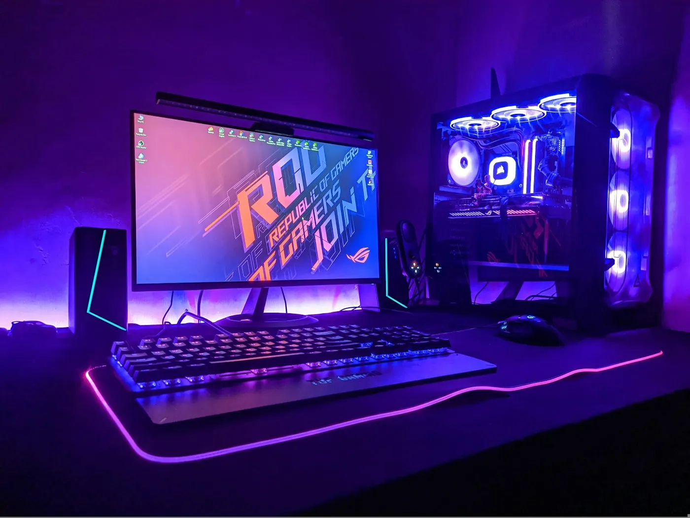 A desktop gaming PC with RGB lighting on a desk