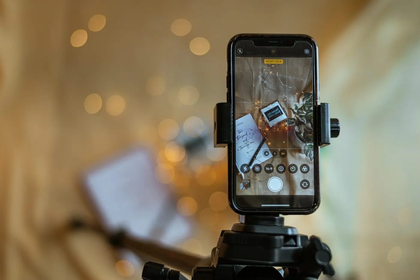 A hand holding a smartphone recording video