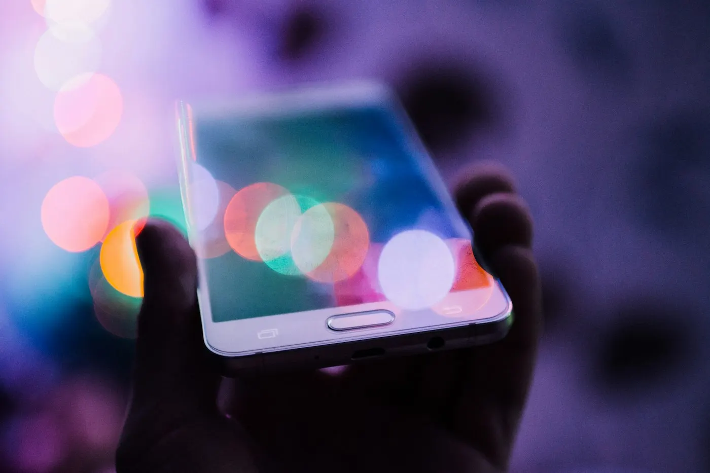 Person holding a smartphone showing its screen