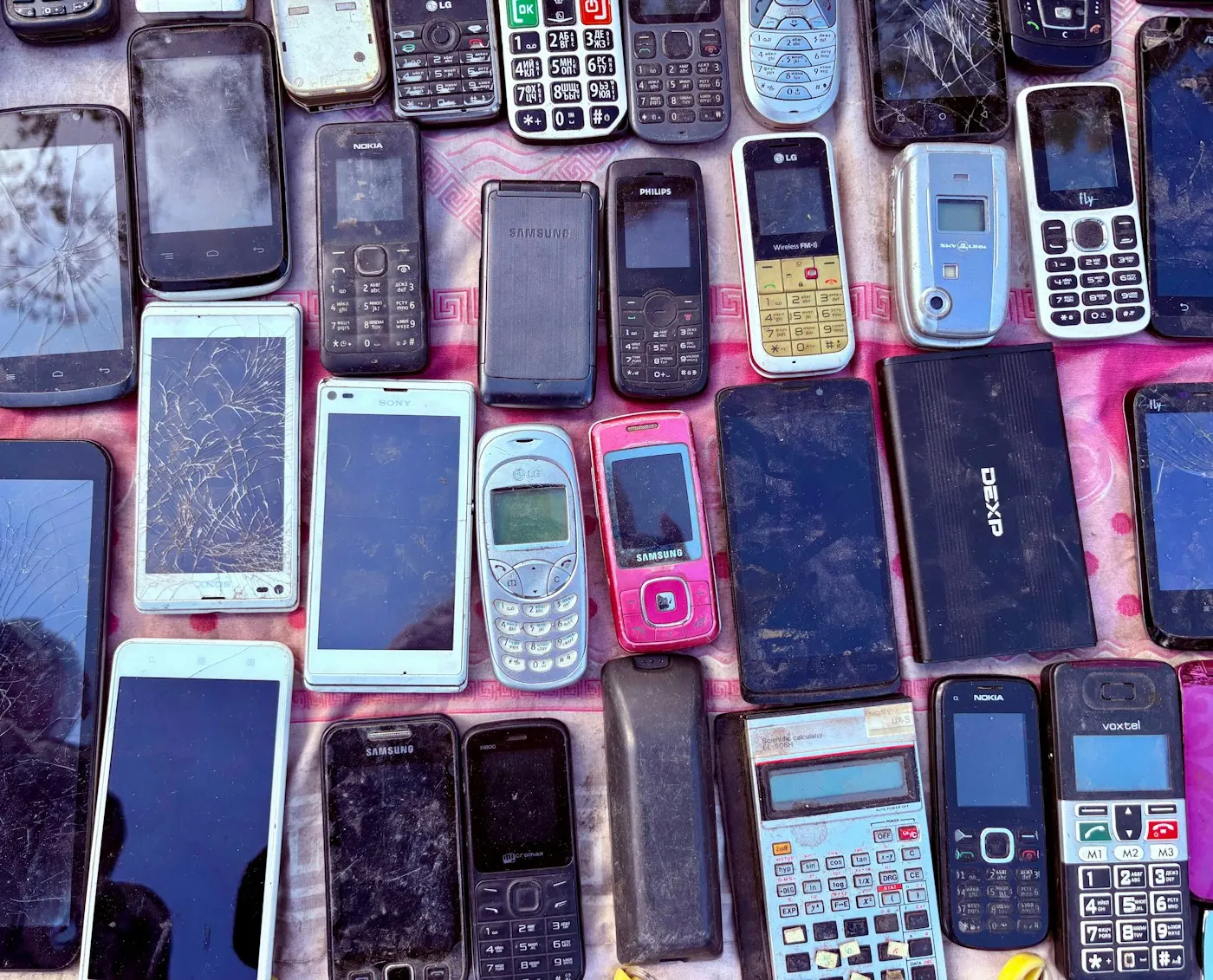 A stack of older smartphones piled together