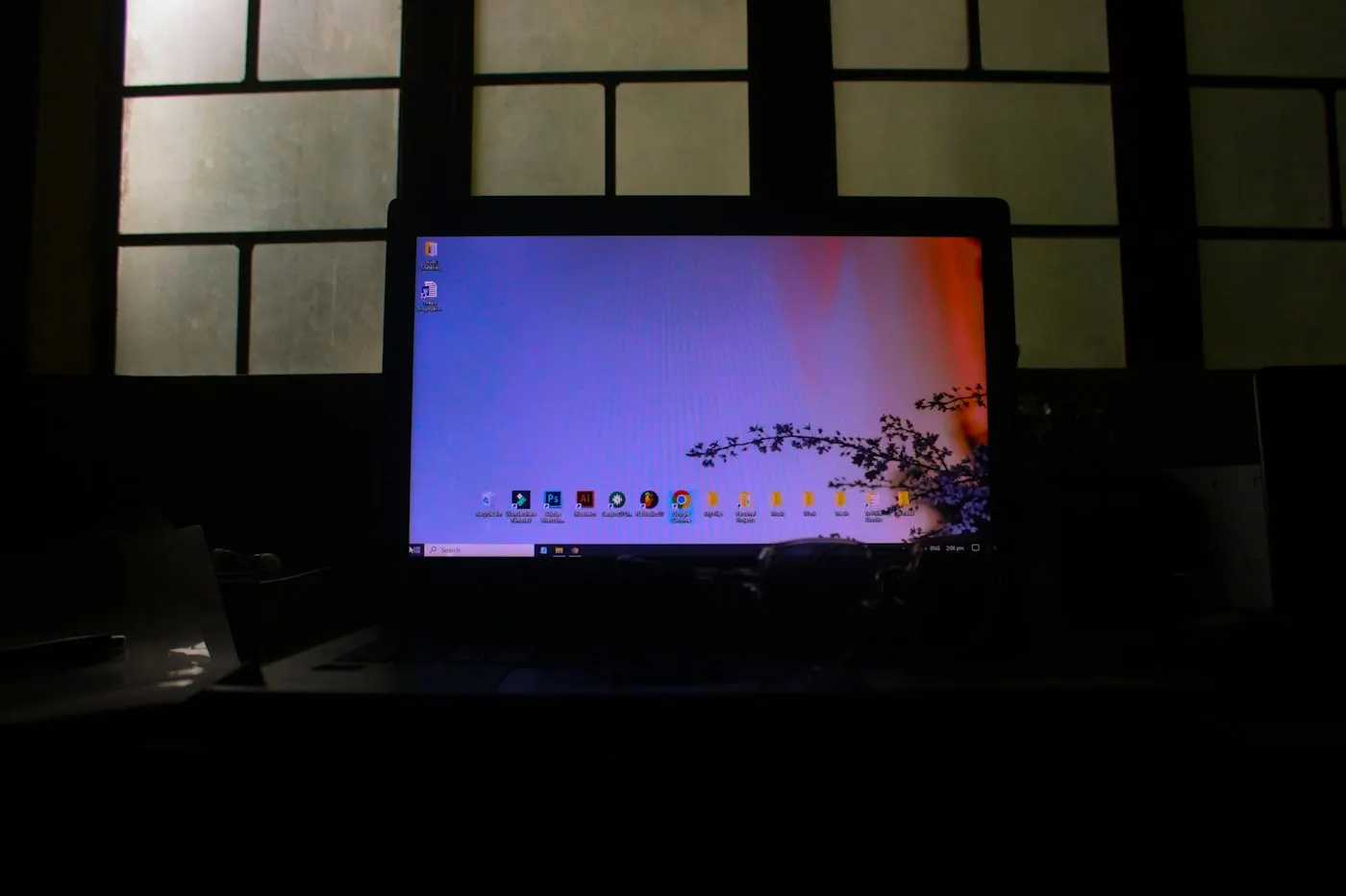 Person typing on a laptop in a dimly lit room
