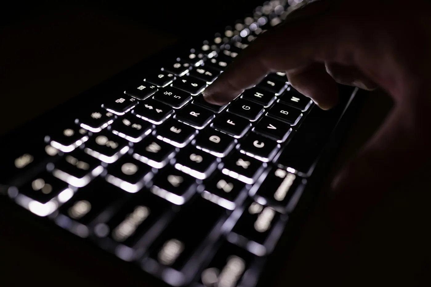Close-up of hands typing on a computer keyboard