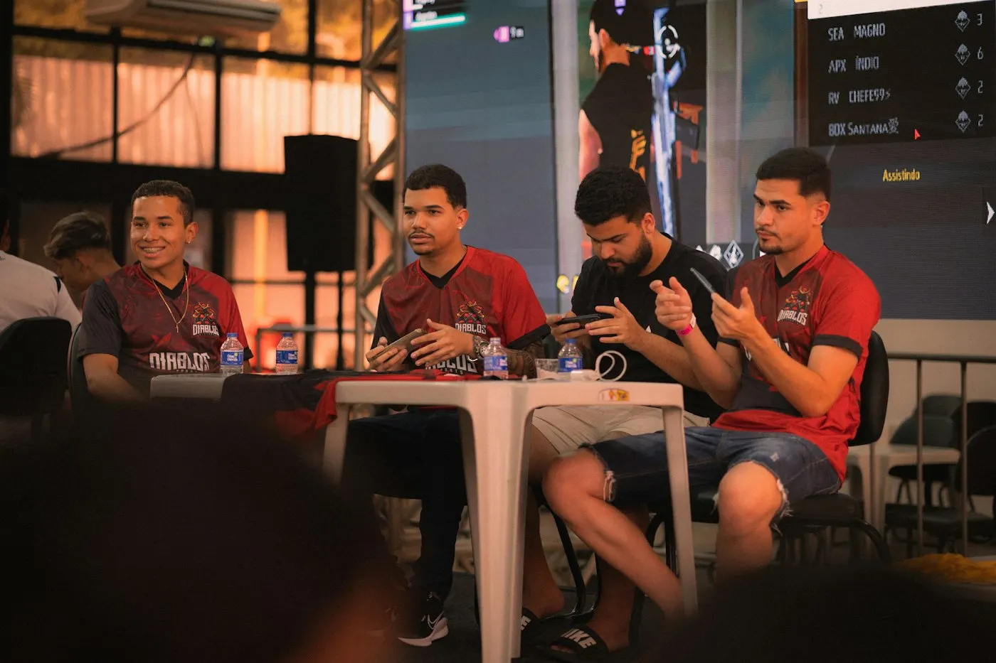 Esports arena filled with fans watching large screens
