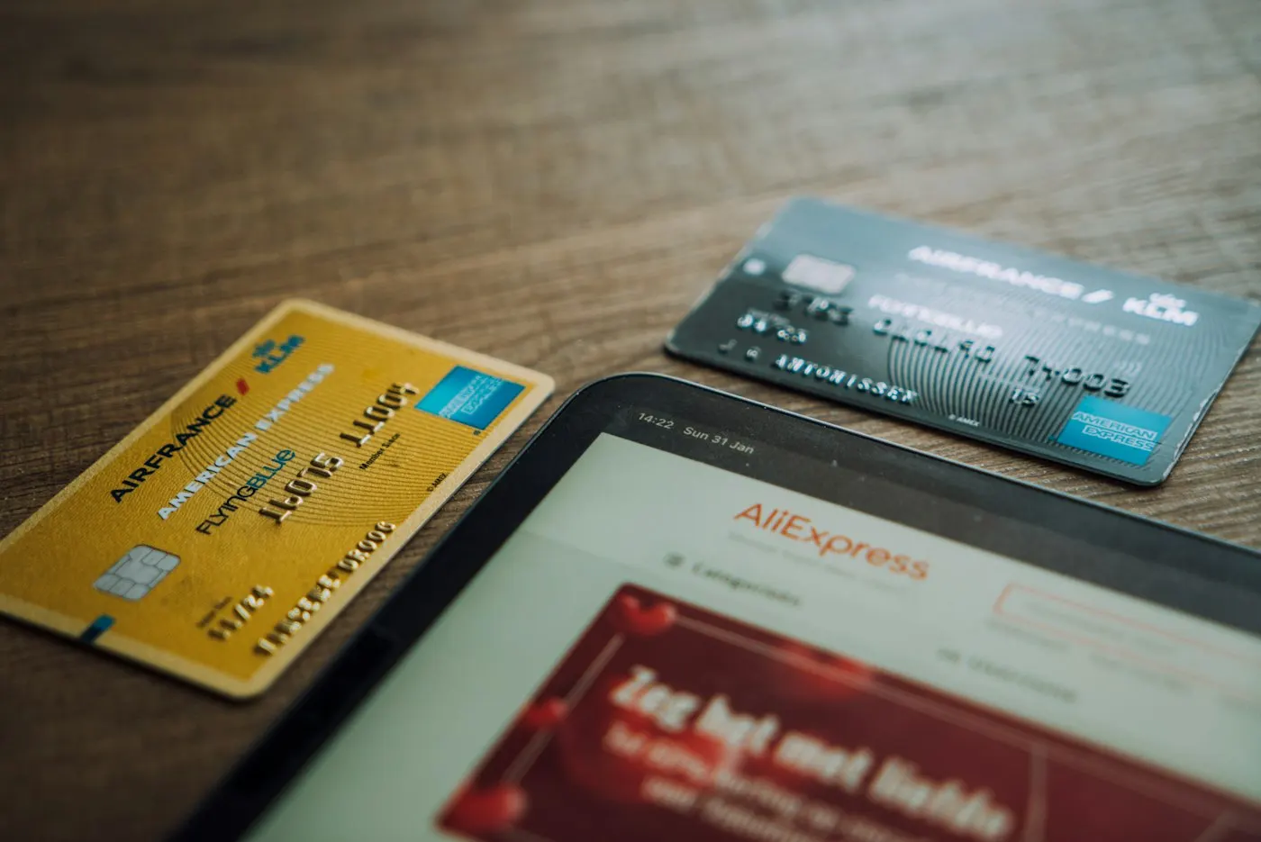 A credit card resting next to a smartphone