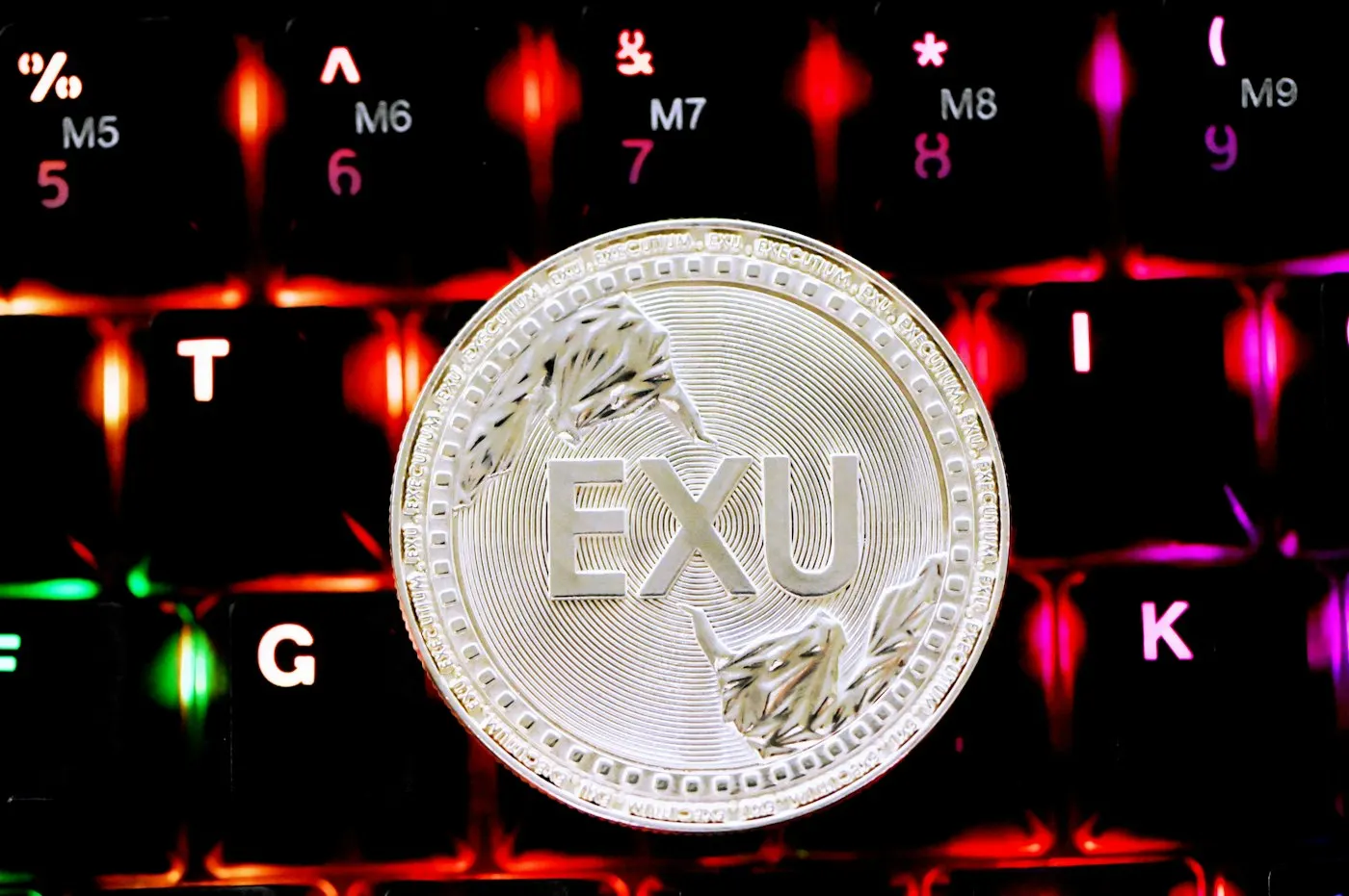 A gold coin resting on a computer keyboard