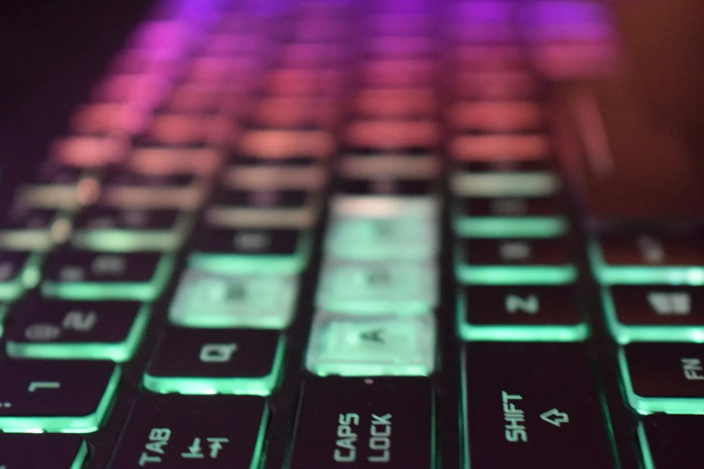 Hands resting on a backlit gaming keyboard