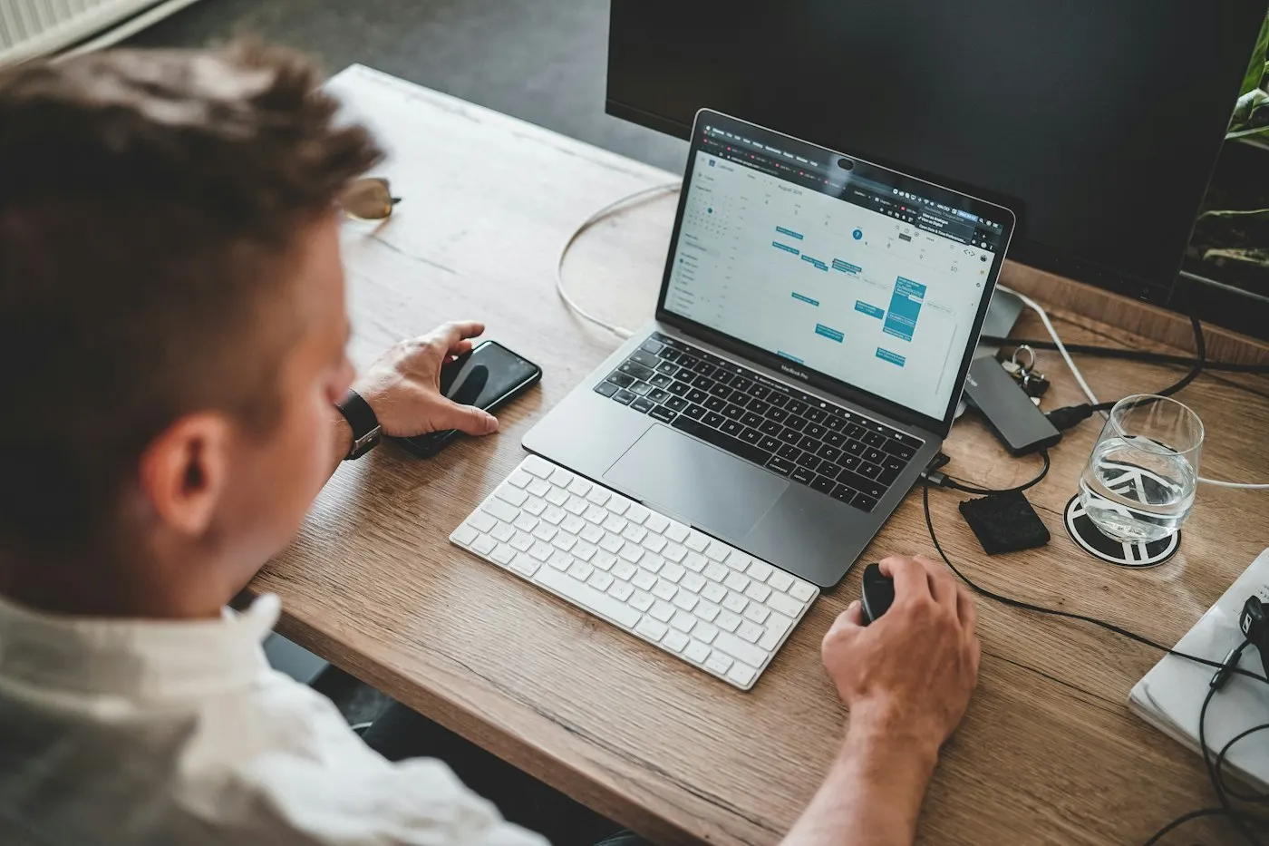 Person typing on a laptop keyboard at a desk