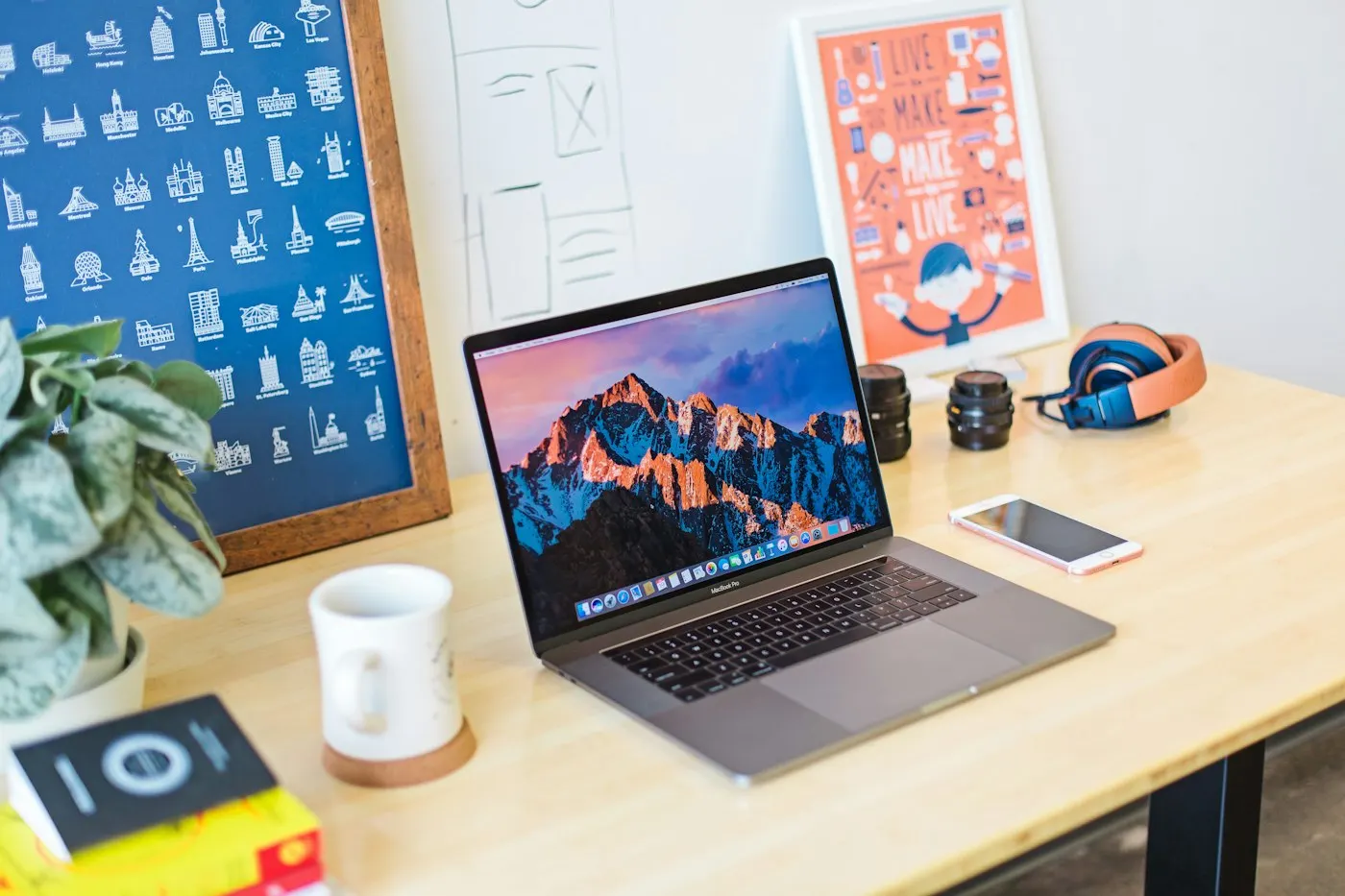 A laptop showing a clean desktop environment on a wooden table