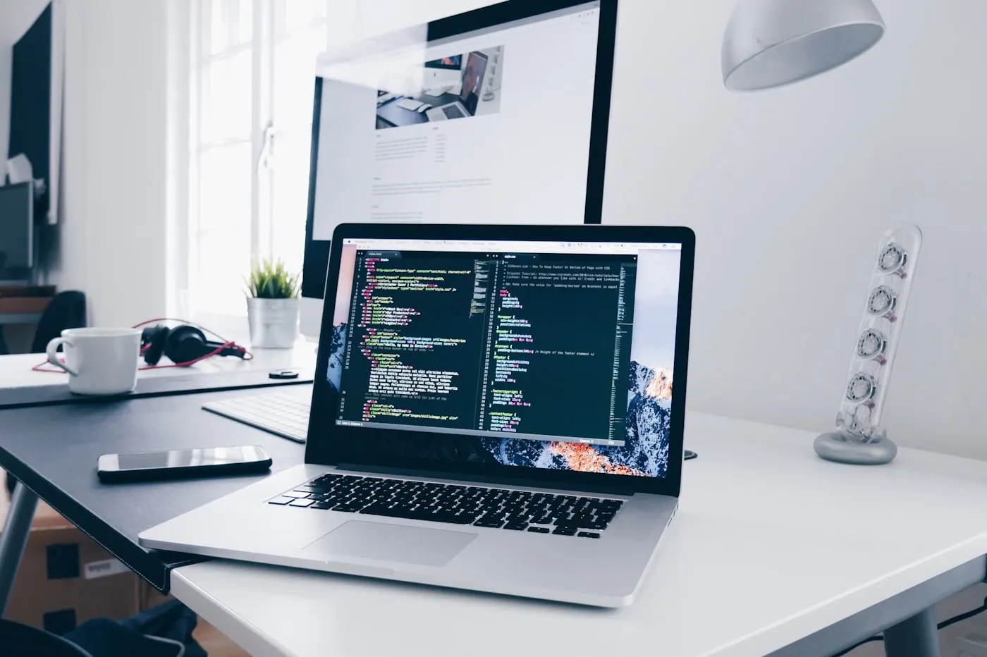 Laptop screen displaying lines of code in an editor