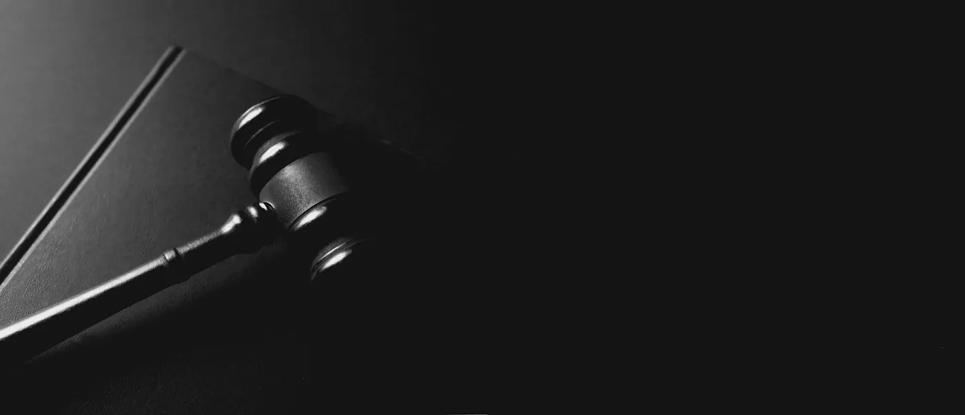 A gavel resting on a wooden desk