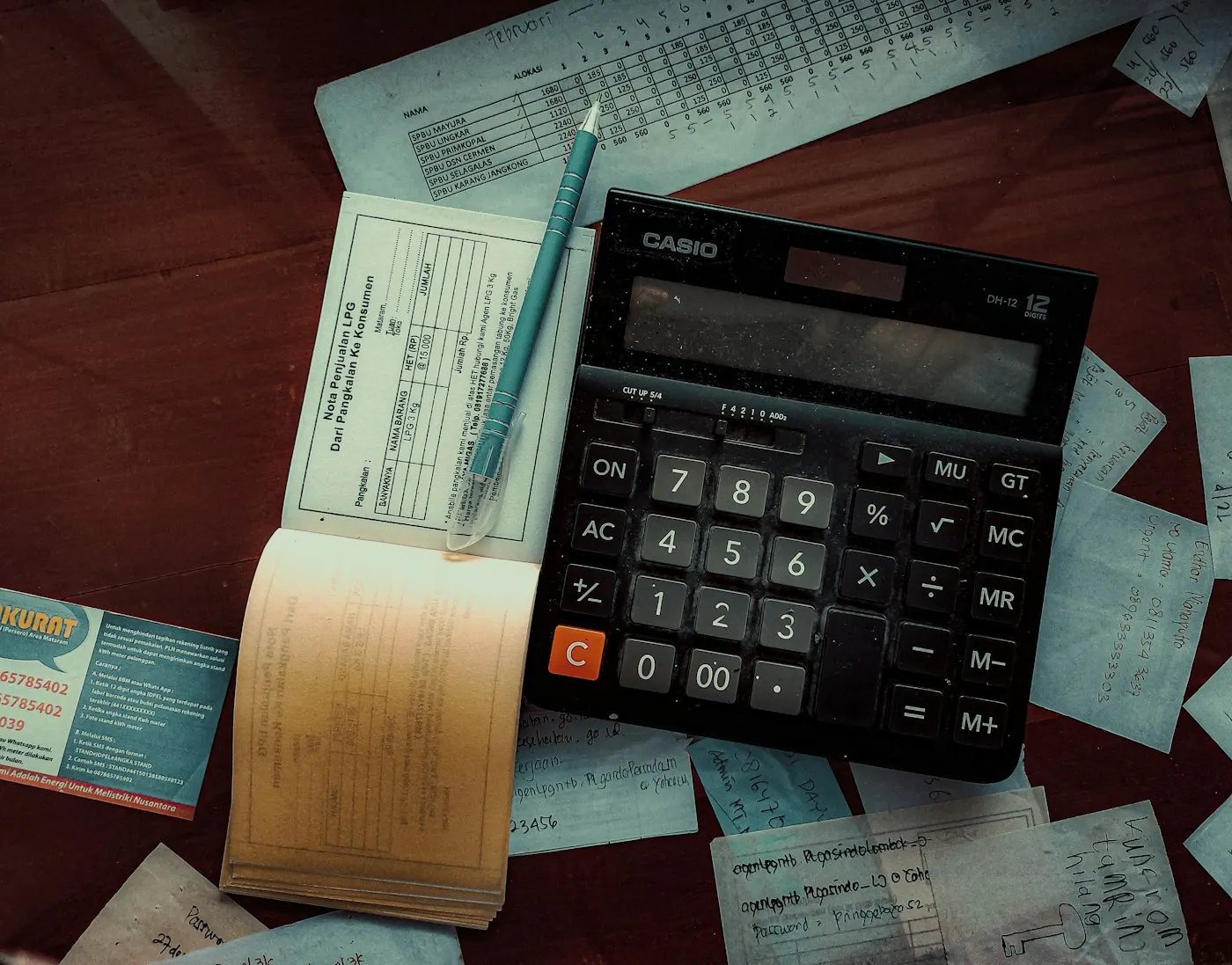 Calculator and invoice papers on an office desk