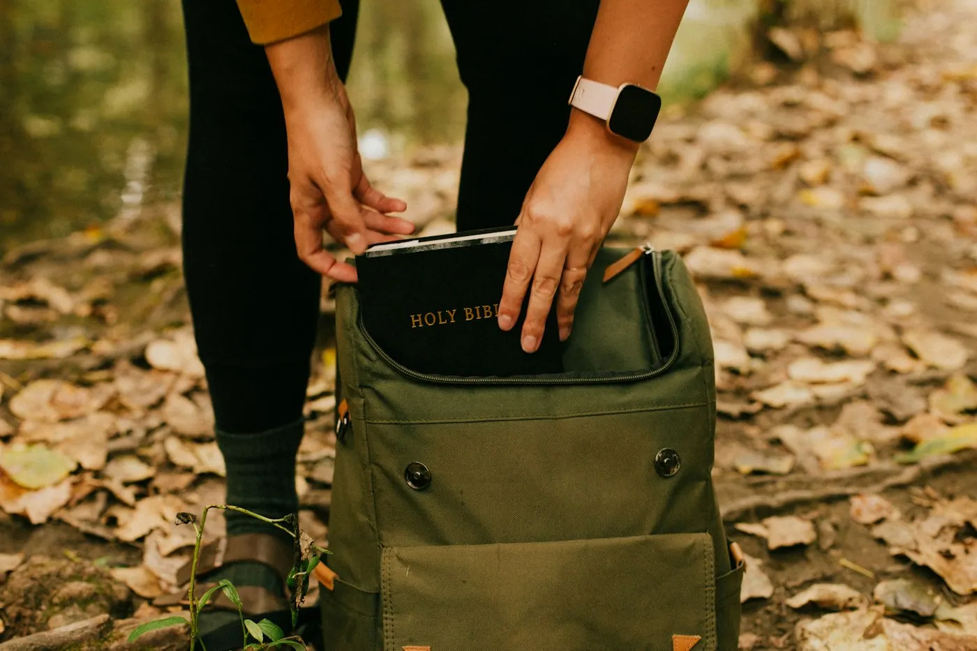A rugged storage drive resting on a backpack outdoors