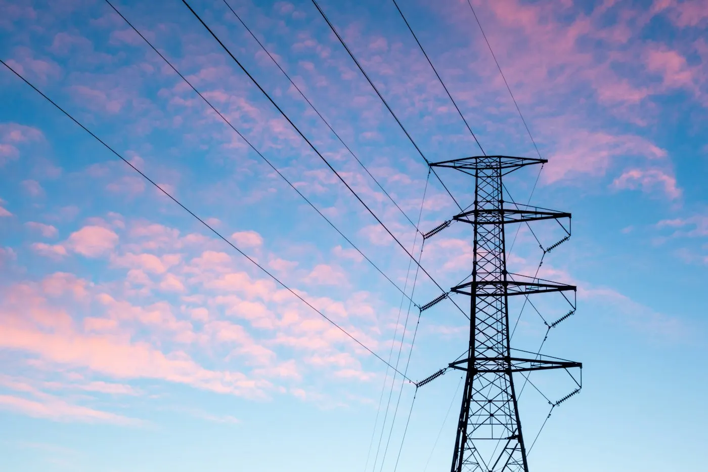 High voltage transmission lines carrying electricity across the countryside