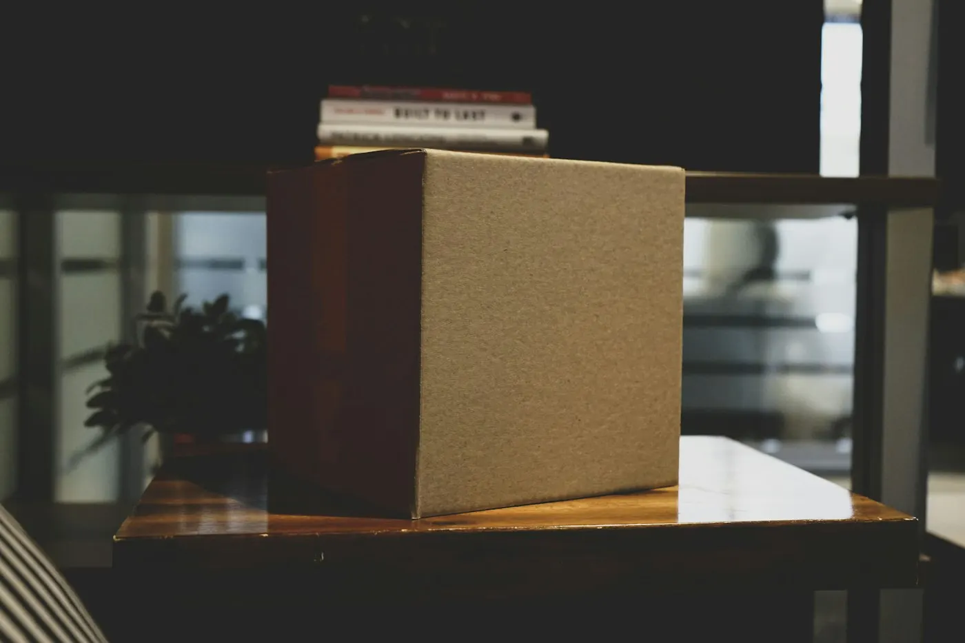 A cardboard box sitting on an empty office desk