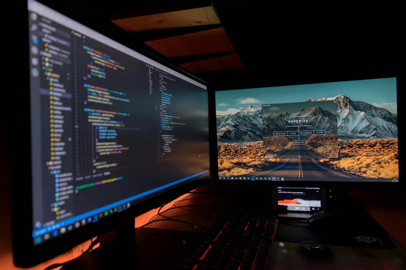 Software developer working late at dual monitors