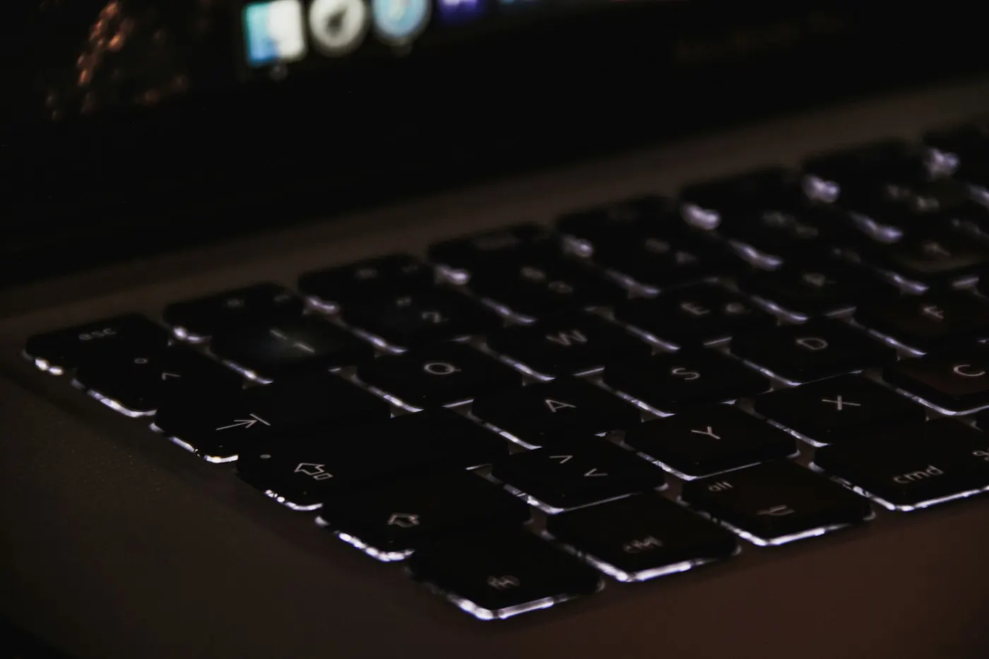 Close-up of hands typing on a laptop keyboard