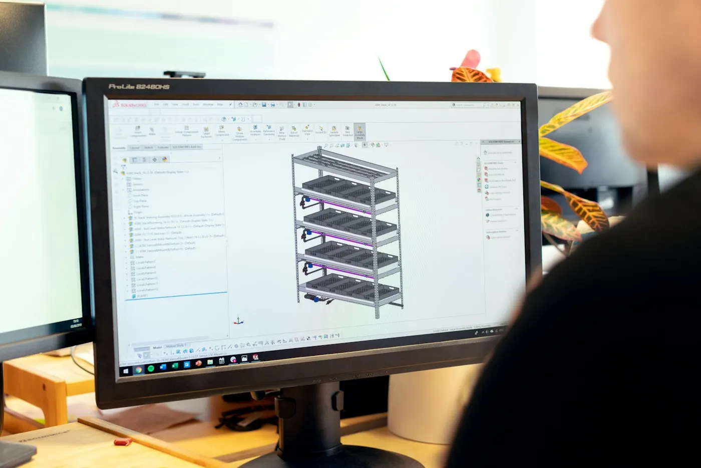 A technician reviewing performance data on multiple monitors
