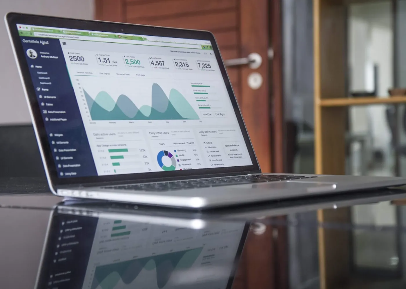 A laptop screen showing a downward financial chart