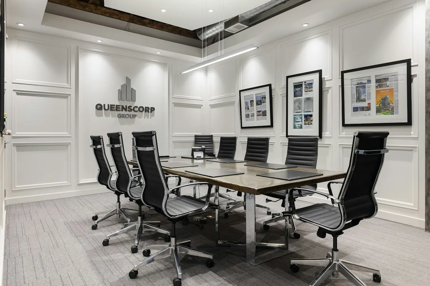 Empty chairs around a corporate boardroom table