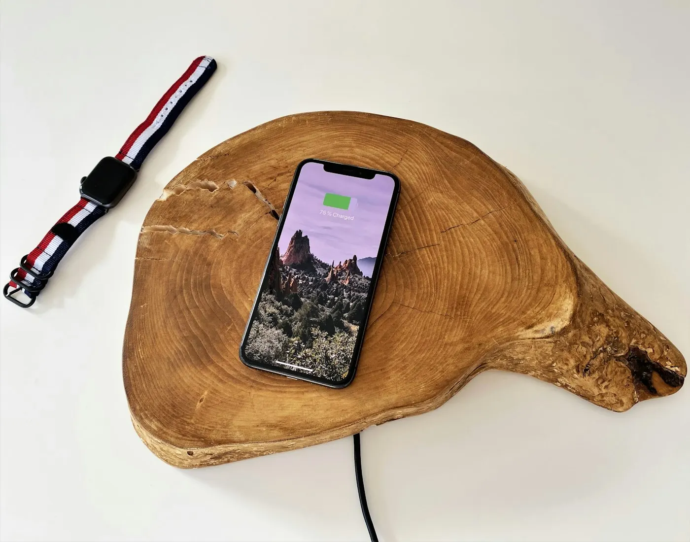 A smartphone charging on a nightstand at night