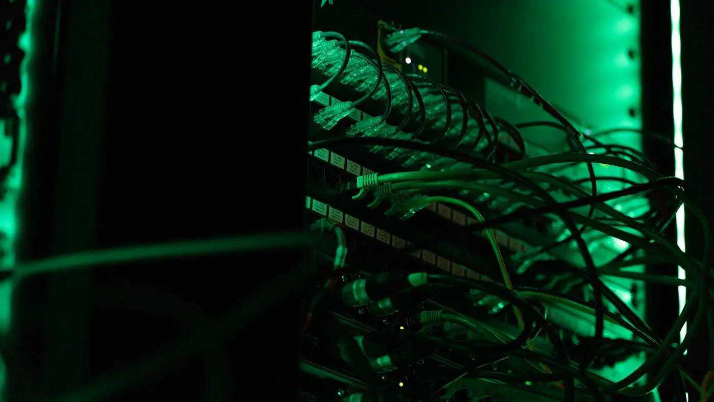 Rows of server racks lit by blue indicator lights