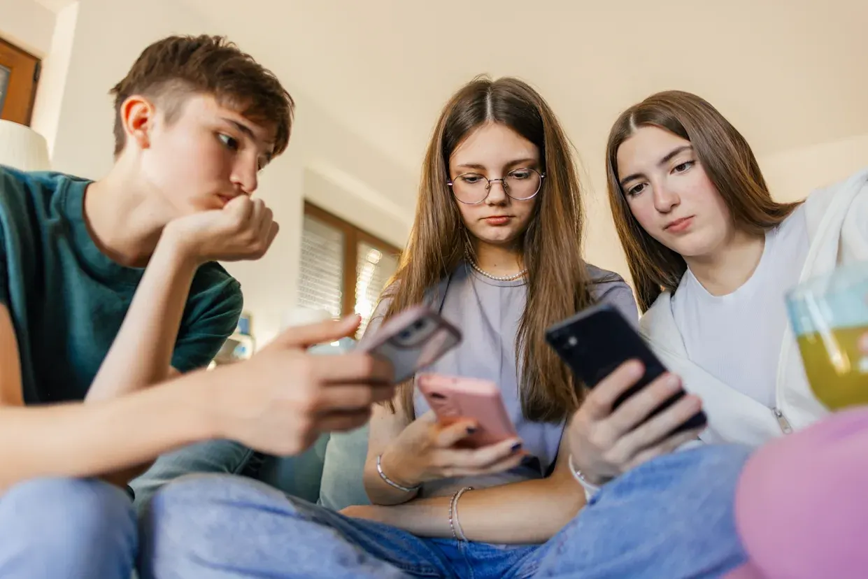 A teenager looking at a smartphone screen