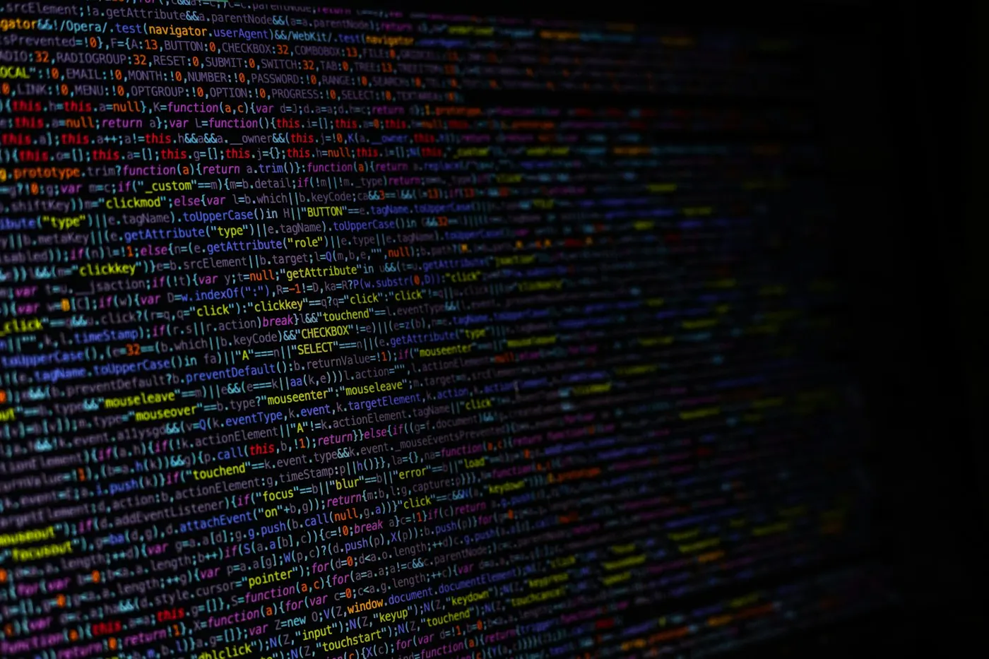 Laptop screen showing lines of code in a dark editor