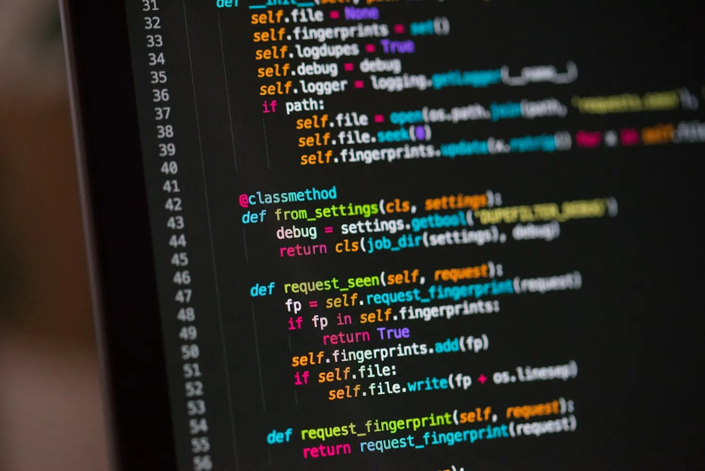 A developer's monitor displaying code in a dark editor