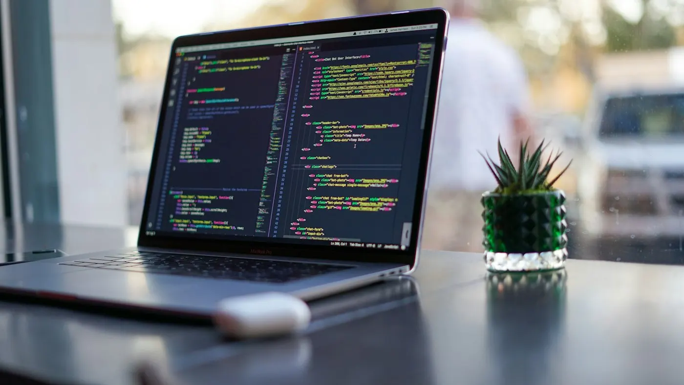 A developer working on code on a laptop