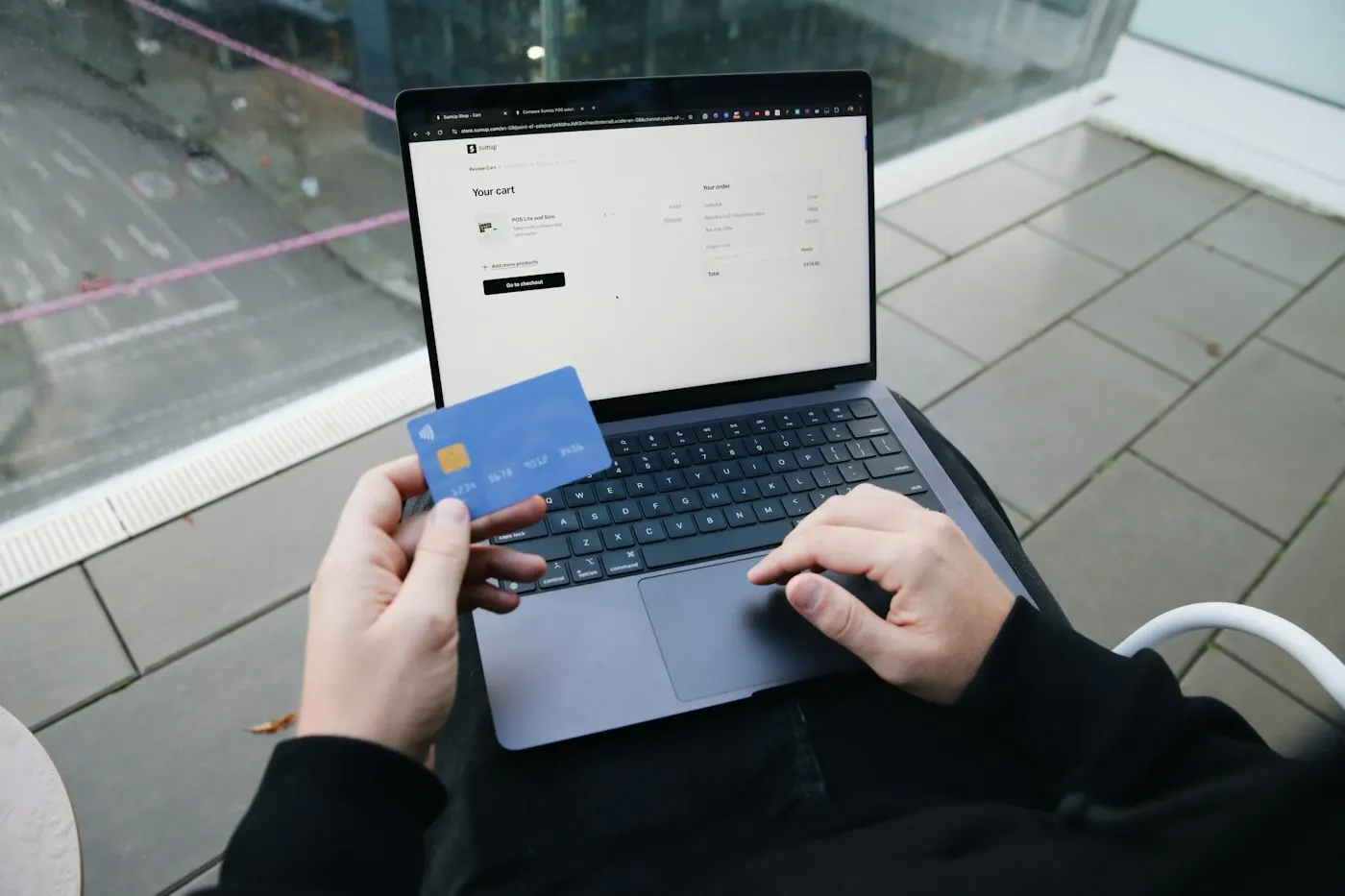 A credit card resting beside a laptop keyboard