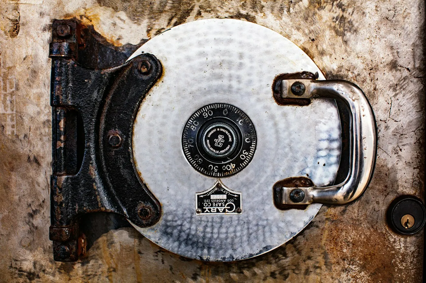 A heavy steel vault door slightly ajar
