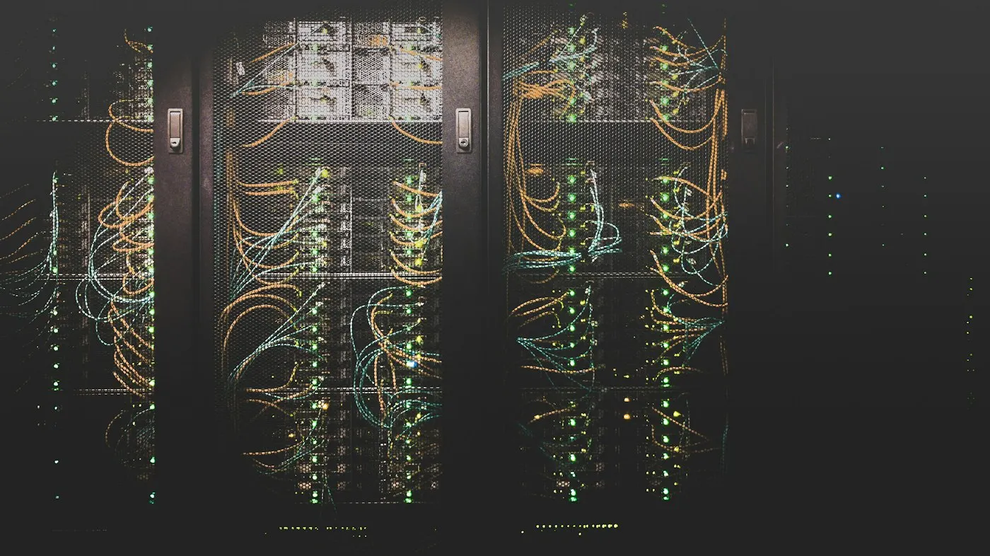 Rows of illuminated server racks in a data center