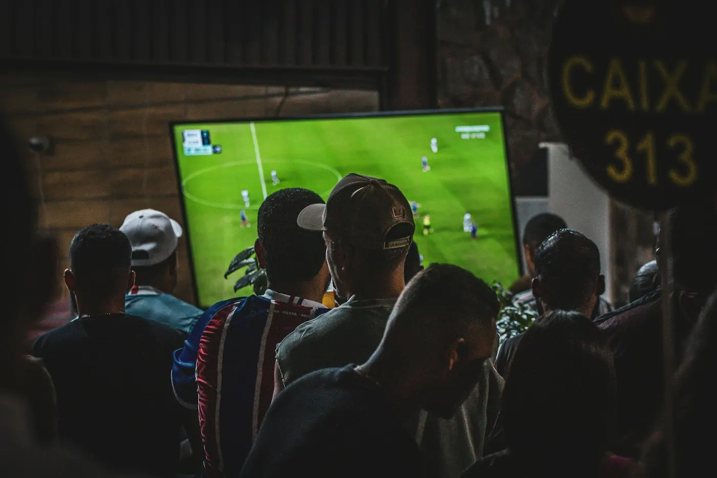 A crowd watching a large screen at an esports event