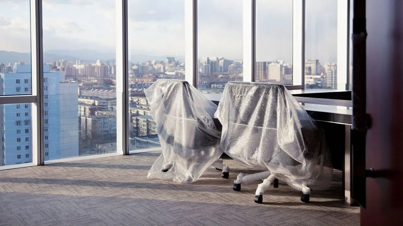 Empty rows of desks in a tech office after large-scale 2026 layoffs