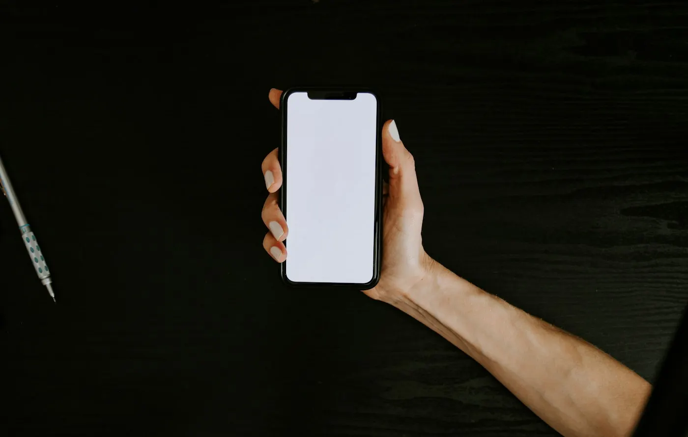 A hand holding a smartphone folded in half
