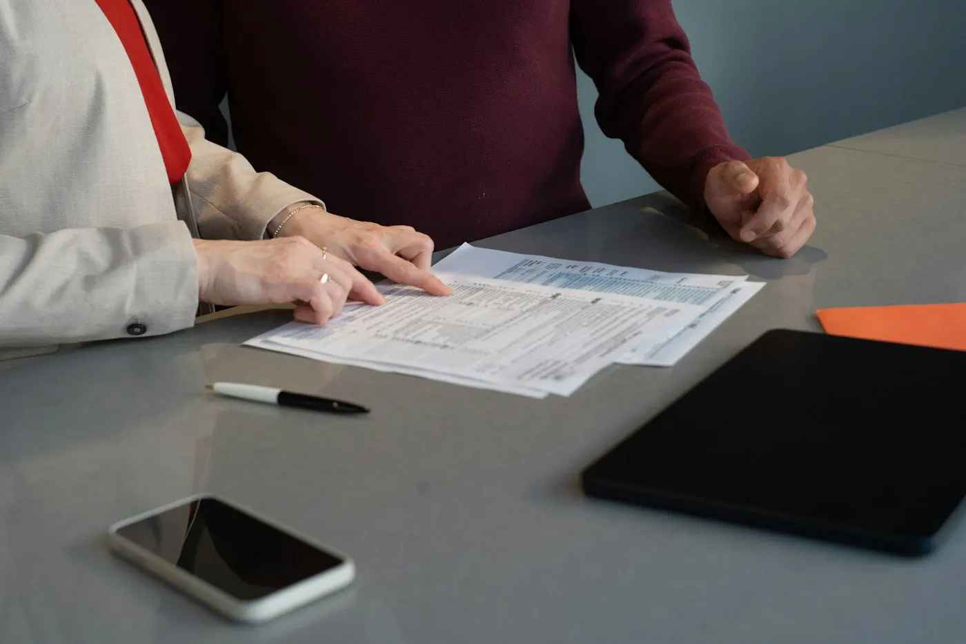 Person reviewing paperwork at a desk