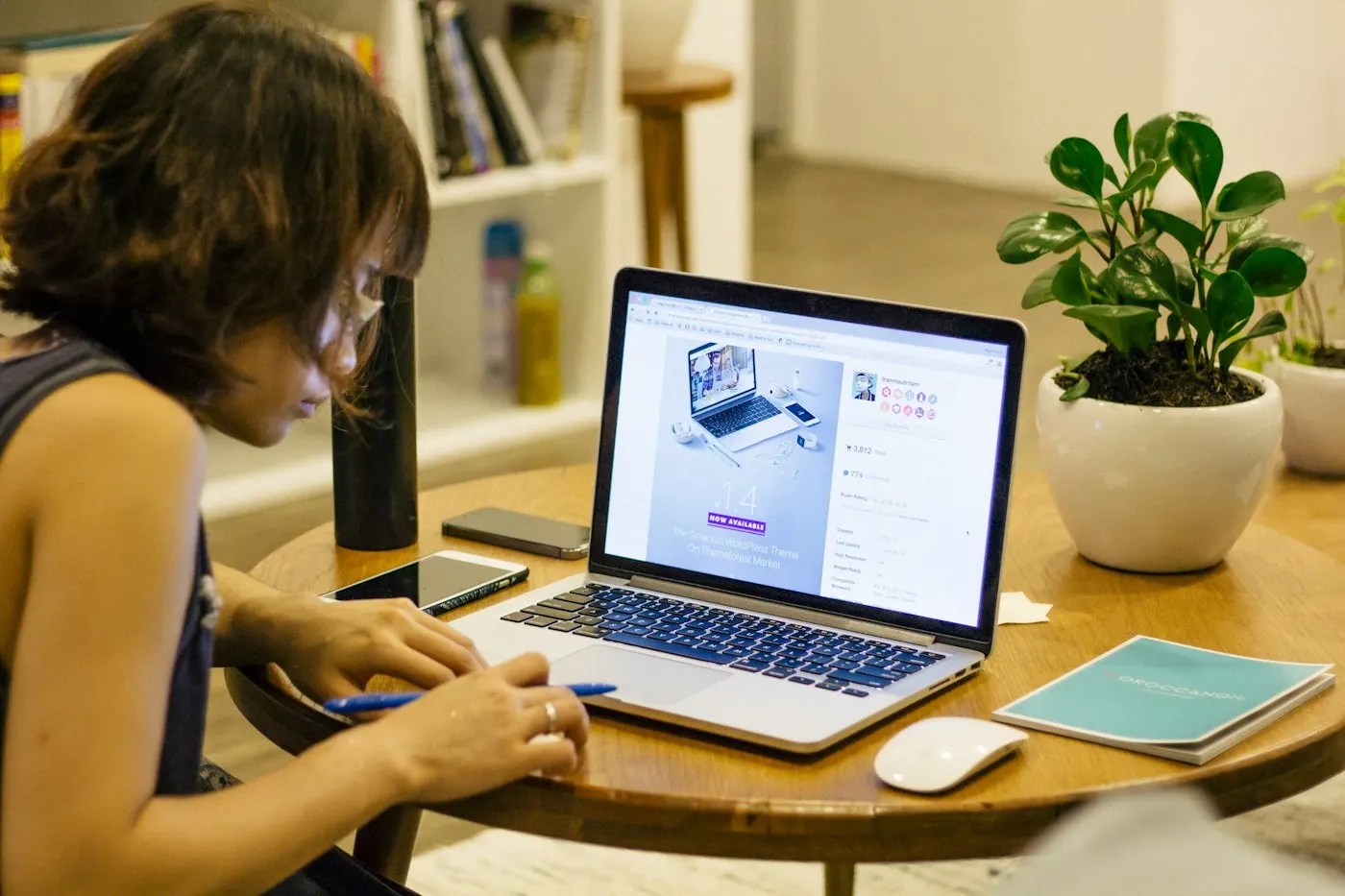 A shopper looking at laptops on a store shelf