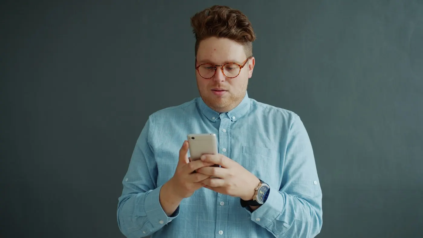 A person typing on a smartphone touchscreen