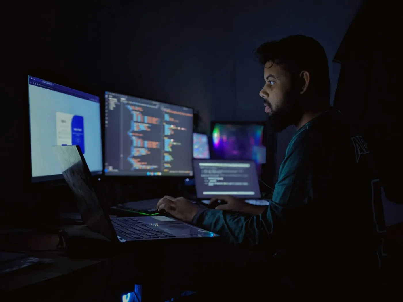 Someone typing on a keyboard in a dim room