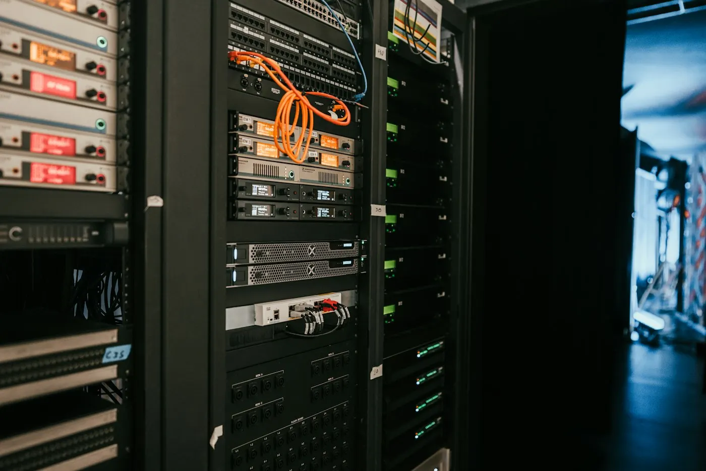 Rows of illuminated server racks in a data center