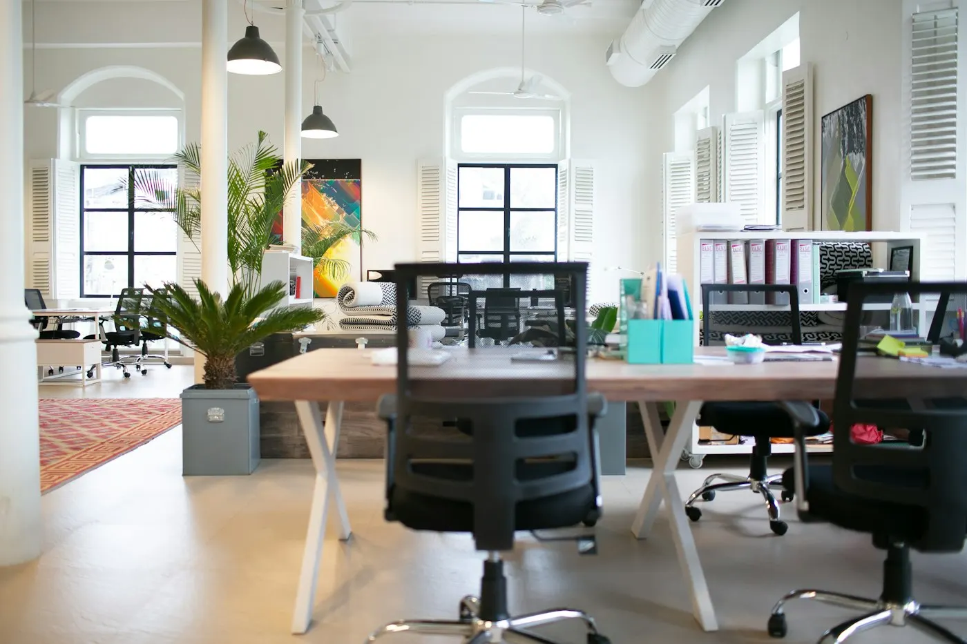 Rows of empty desks in a modern office space