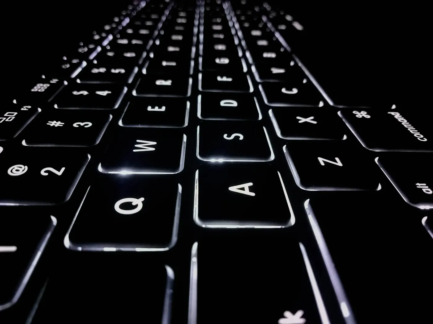 Close-up of hands typing on a laptop keyboard