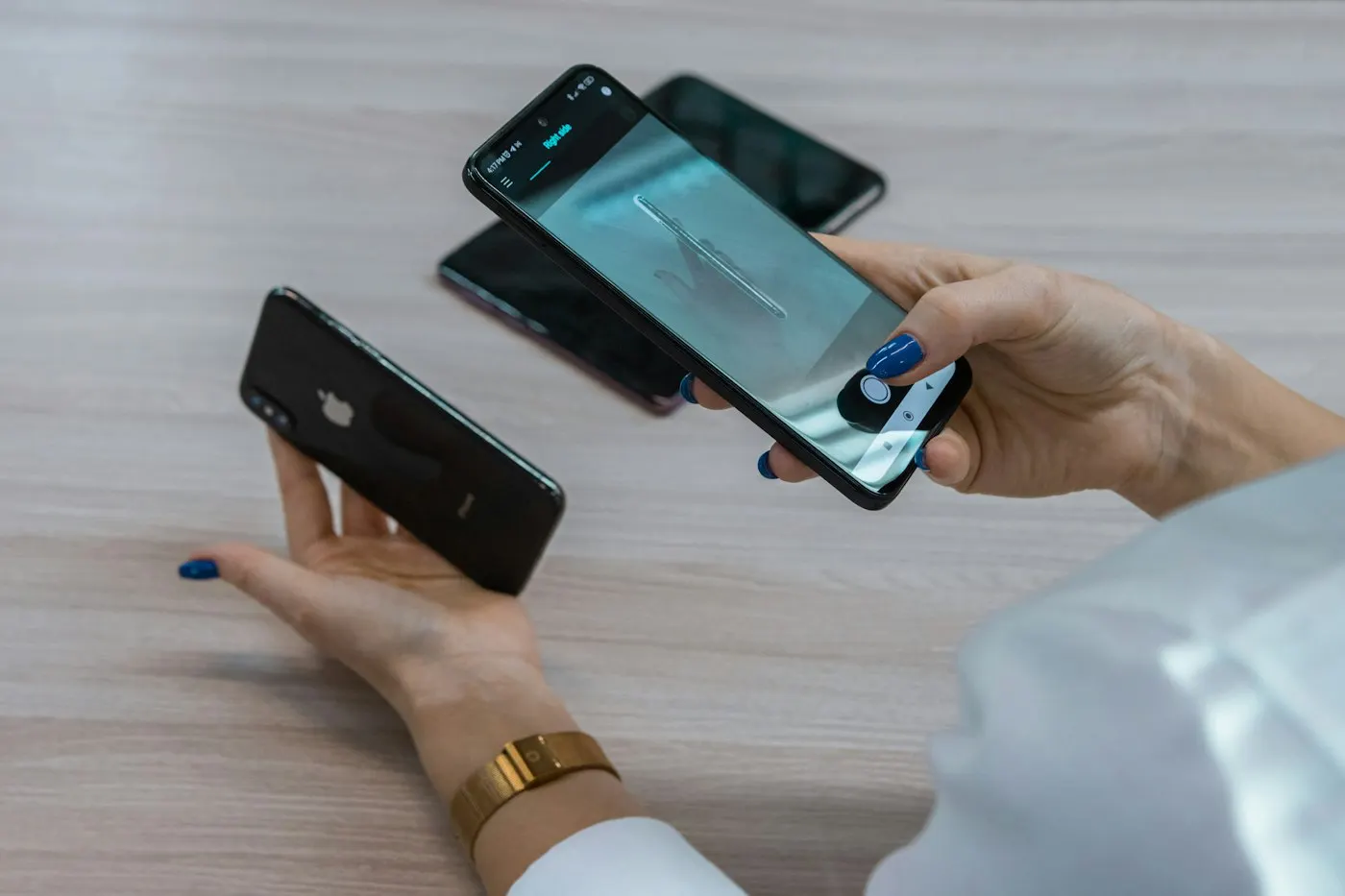 Person holding two smartphones side by side