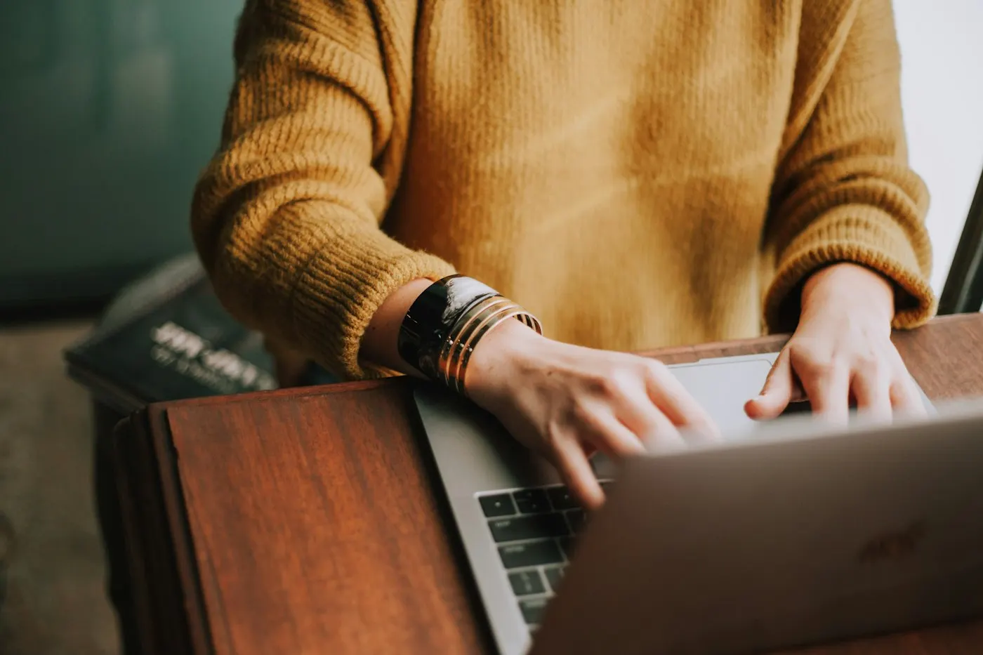 A programmer typing on a laptop keyboard