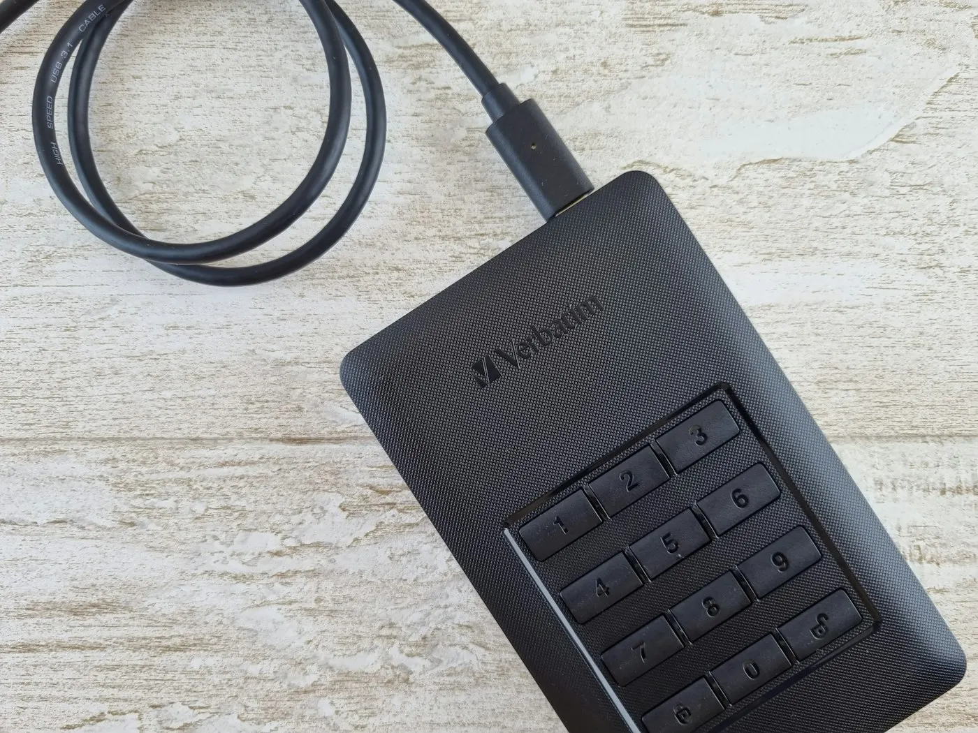 A portable storage drive sitting on a desk