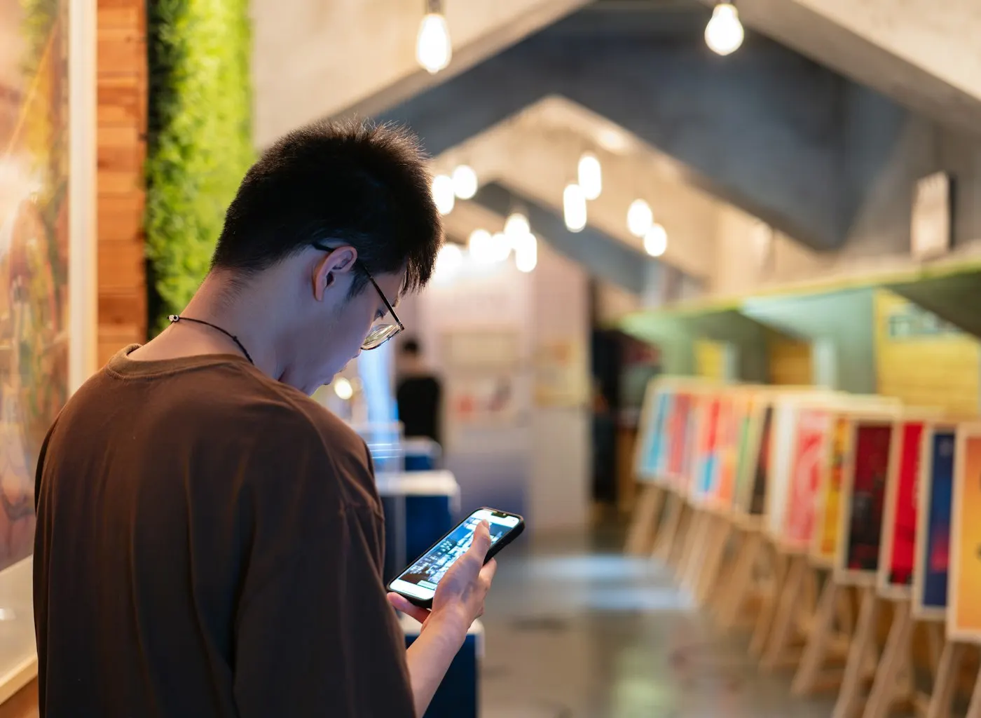 A shopper comparing two smartphones in a retail store