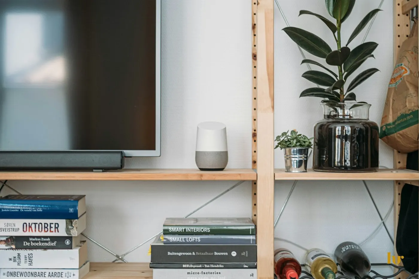 A smart speaker on a shelf in a living room