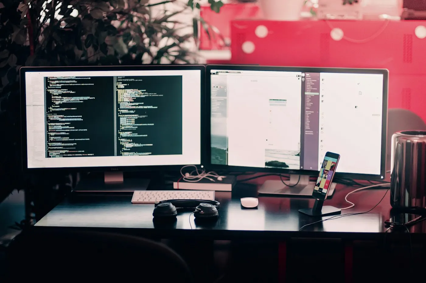 A developer's desk with dual monitors and a laptop